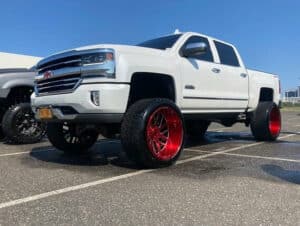 White truck with red wheels
